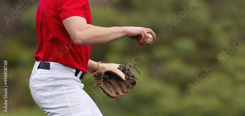 Baseball pitcher ready to pitch in baseball game, college softball player photo