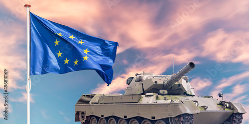 Official flag of the Europian Union in front of a military tank photo