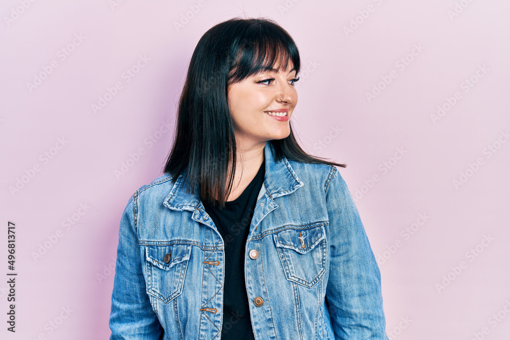 Young hispanic woman wearing casual clothes looking to side, relax profile pose with natural face and confident smile. Young hispanic woman wearing casual clothes looking to side, relax profile pose with natural face and confident smile.