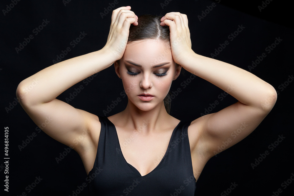 Fototapeta premium Beauty portrait of young woman. Brunette girl with evening female makeup and black dress