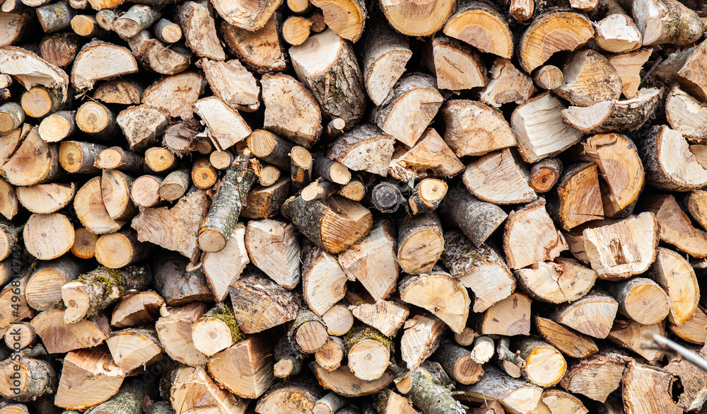 Background from a stack of firewood for a fireplace. Renewable energy source. Background from a stack of firewood for a fireplace. Renewable energy source.