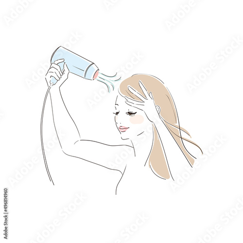 ヘアドライヤーで髪を乾かす美しい女性