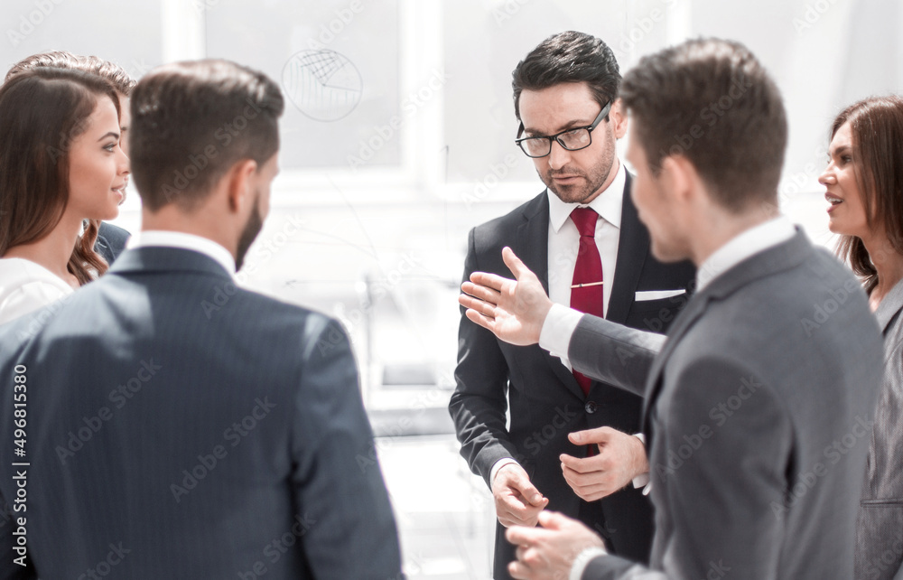 close up.a group of employees talking standing in a circle close up.a group of employees talking standing in a circle