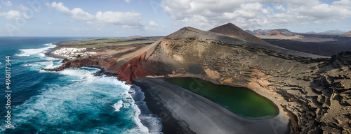 Aerial panoramic view of El Lago Verde (Green Lake) along the coast with black sand beach near El Golfo, Lanzarote, Canary Islands, Spain.