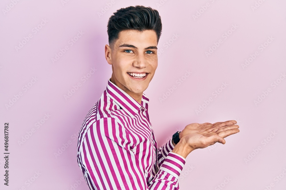 Young hispanic man wearing casual clothes pointing aside with hands open palms showing copy space, presenting advertisement smiling excited happy Young hispanic man wearing casual clothes pointing aside with hands open palms showing copy space, presenting advertisement smiling excited happy