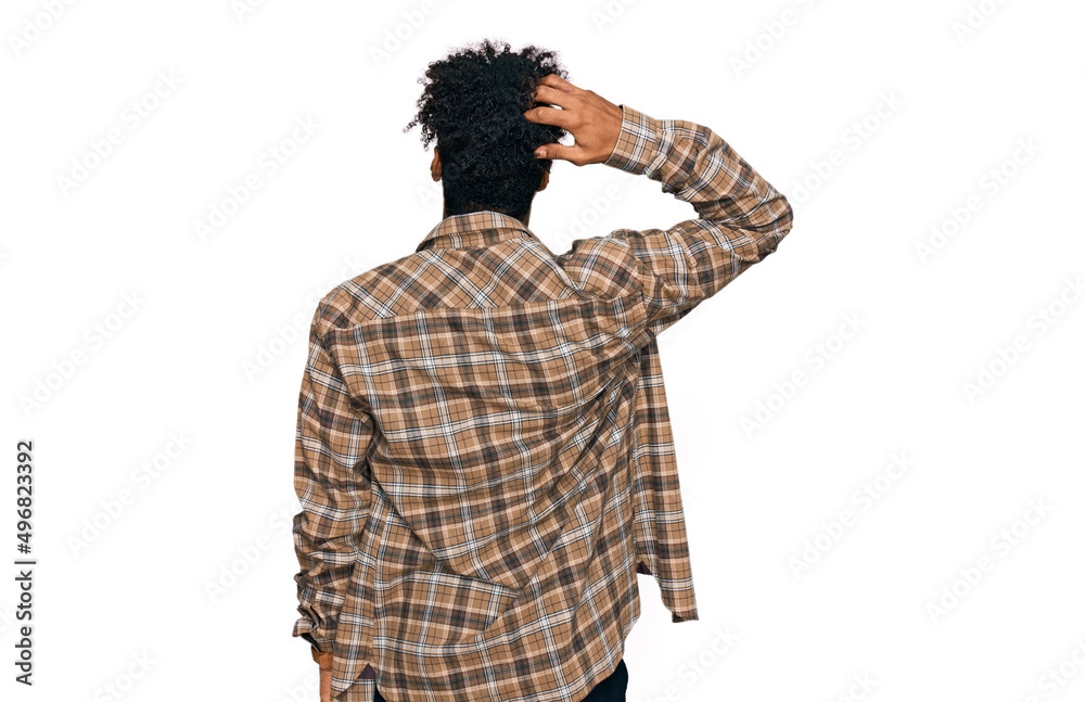 Young african american man with beard wearing casual clothes and glasses backwards thinking about doubt with hand on head Young african american man with beard wearing casual clothes and glasses backwards thinking about doubt with hand on head