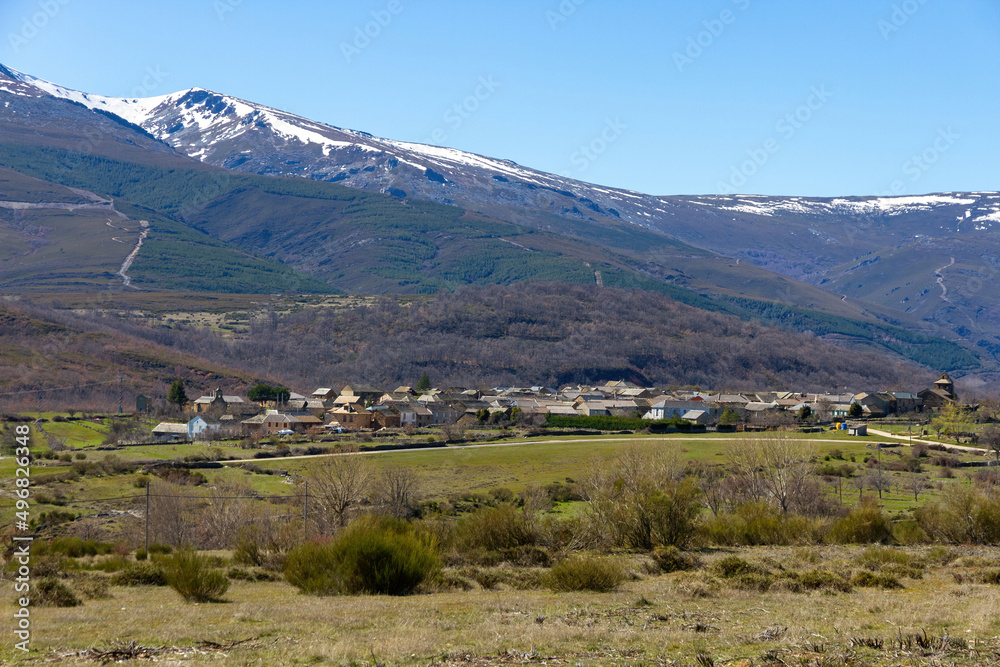 General view of the small traditional village of Chana de Somoza with snowy mountains, Leon Province, Spain
