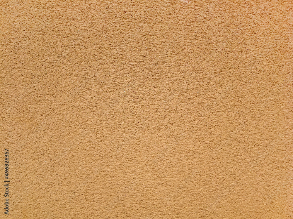 Rough plastered wall texture or background in light earthy tone Rough plastered wall texture or background in light earthy tone