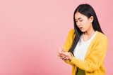 Portrait of Asian beautiful young woman suffering from pain in palm or hands and massaging her painful hands, studio shot isolated on pink background, Health care arthritis concept