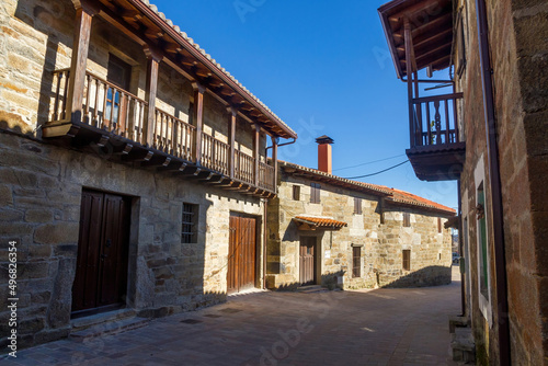 Street of the town of Villardeciervos with old stone buildings and wooden balconies. Zamora. Spain  photo