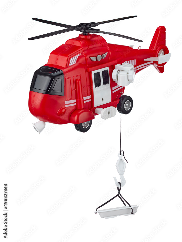Red toy rescue helicopter with a rescue cradle on a cord, isolated on a white background. Rescue and evacuation from hard-to-reach places.