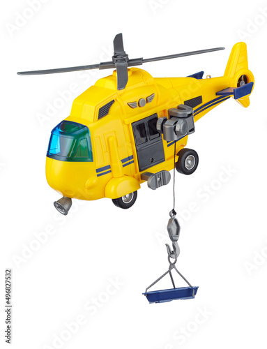Yellow toy rescue helicopter with a rescue cradle on a cord, isolated on a white background. Rescue and evacuation from hard-to-reach places.