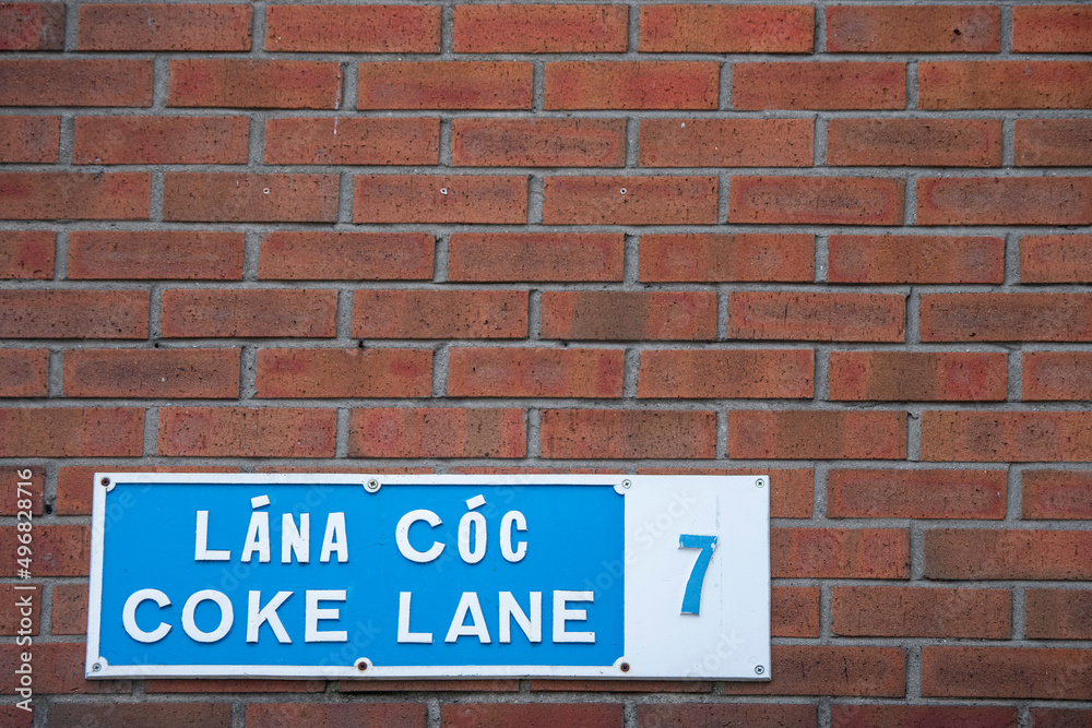 Fototapeta premium Sign Coke lane 7 in Irish and English language on a street in Dublin city, Ireland. Copy space. Slang word for highly expensive drug cocaine.