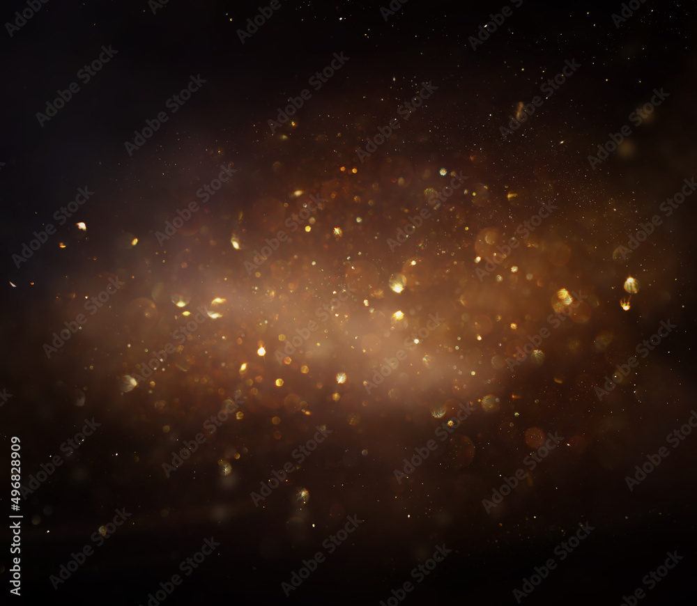 Fototapeta premium background of abstract glitter lights. gold and black. de focused