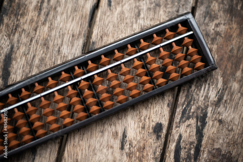 Close up abacus on wood table.