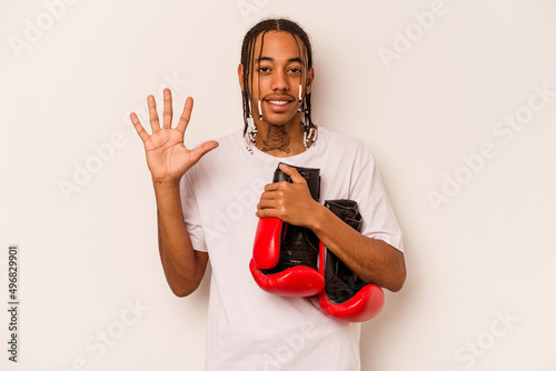 Young African American man playing boxing isolated on white background smiling cheerful showing number five with fingers.