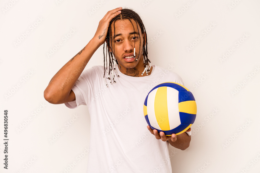 Young African American man playing volleyball isolated on white background being shocked, she has remembered important meeting.