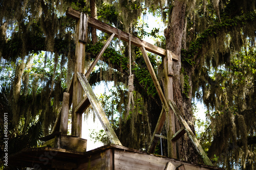 View of an old wooden gallows with a noose under the trees in St. Augustine, Florida photo