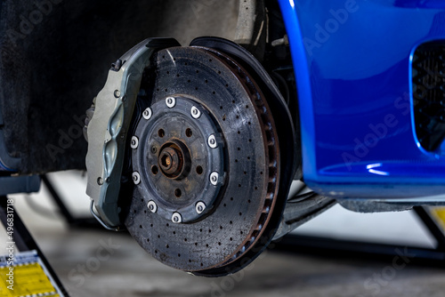Close up of a modern car brakes during maintenance repair, transport concept