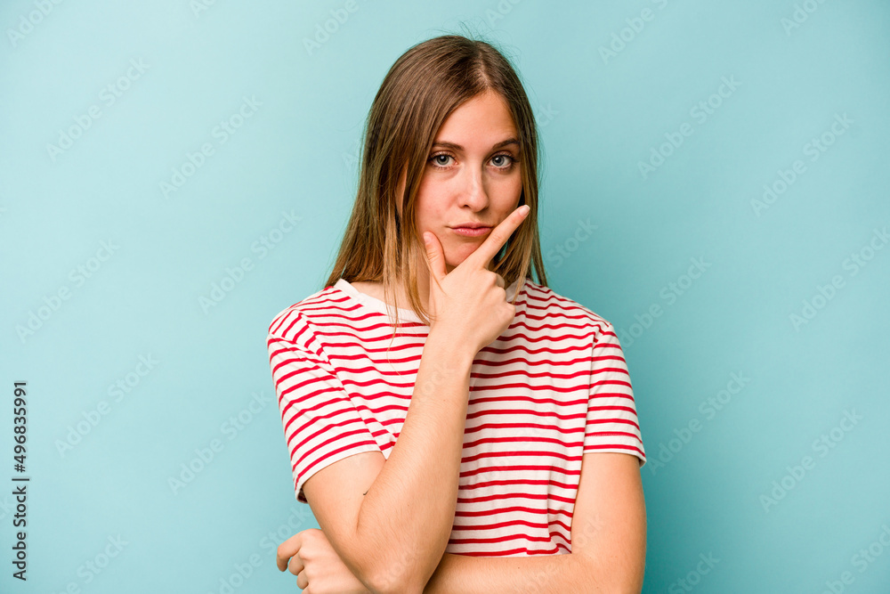 Young caucasian woman isolated on blue background contemplating, planning a strategy, thinking about the way of a business. Young caucasian woman isolated on blue background contemplating, planning a strategy, thinking about the way of a business.