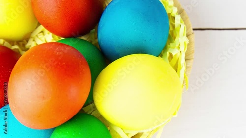Easter eggs in brown bowl. Happy Easter holiday. Colorful painted eggs. Bright boiled eggs. Easter traditional decoration. Christian holiday. Easter celebration. Spring holidays concept.