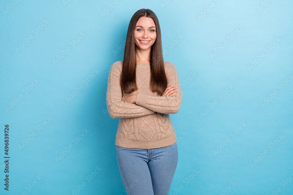 Portrait of attractive cheerful content brown-haired girl folded arms isolated over vibrant blue color background Portrait of attractive cheerful content brown-haired girl folded arms isolated over vibrant blue color background