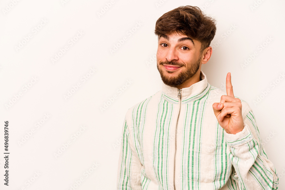 Young hispanic man isolated on white background showing number one with finger. Young hispanic man isolated on white background showing number one with finger.