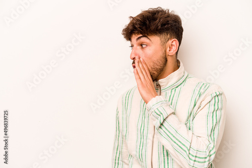 Young hispanic man isolated on white background being shocked because of something she has seen.