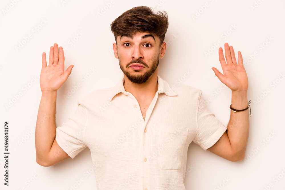 Fototapeta premium Young hispanic man isolated on white background being shocked due to an imminent danger