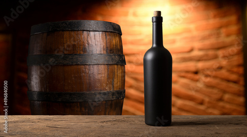 red wine bottle and wine glass on wodden barrel
