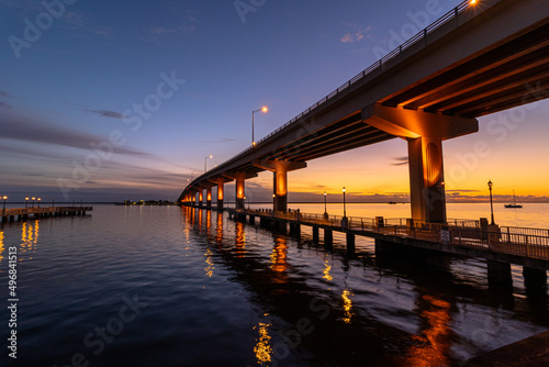 Scenic view of the Max Brewer Bridge and its reflection on water during sunrise in Titusville photo