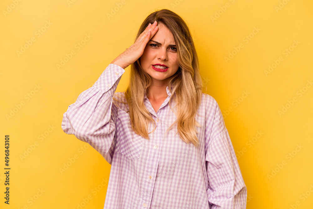 Young caucasian woman isolated on yellow background forgetting something, slapping forehead with palm and closing eyes. Young caucasian woman isolated on yellow background forgetting something, slapping forehead with palm and closing eyes.