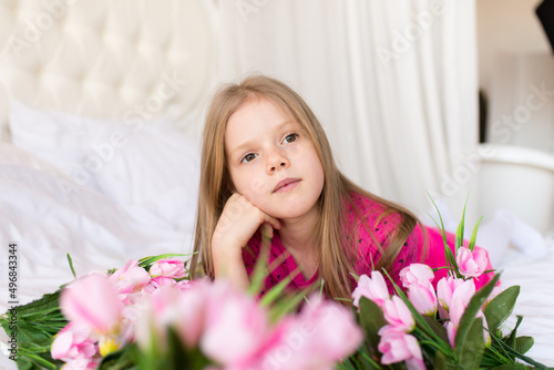 Portrait of a cute little girl with flowers. Spring portrait. Mothers Day. 