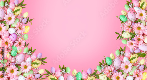 Easter pink background with eggs and flowers . Top view flat lay background . Greeting card pattern with copy space.