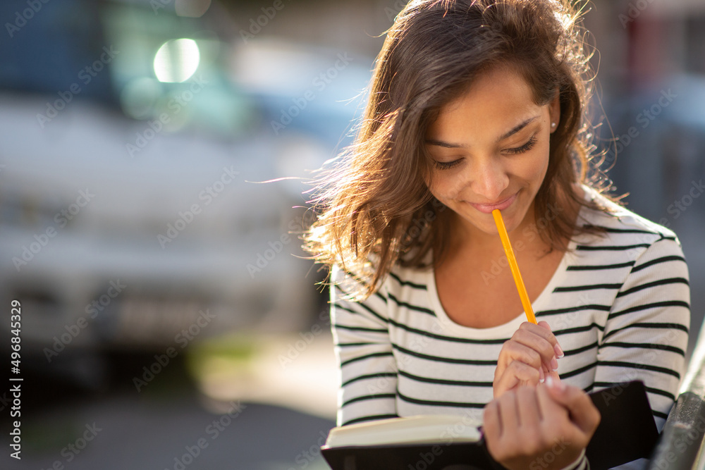 Close up young woman thinking while looking at book Close up young woman thinking while looking at book