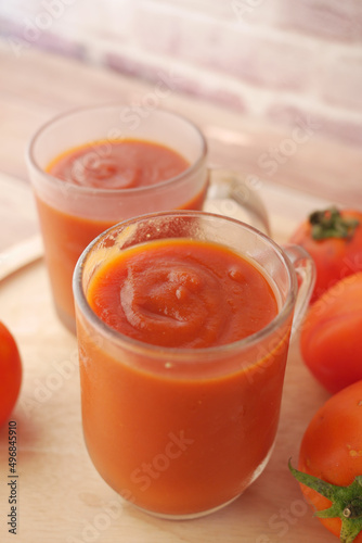  tomato sauce in a jar with fresh tomato on table 