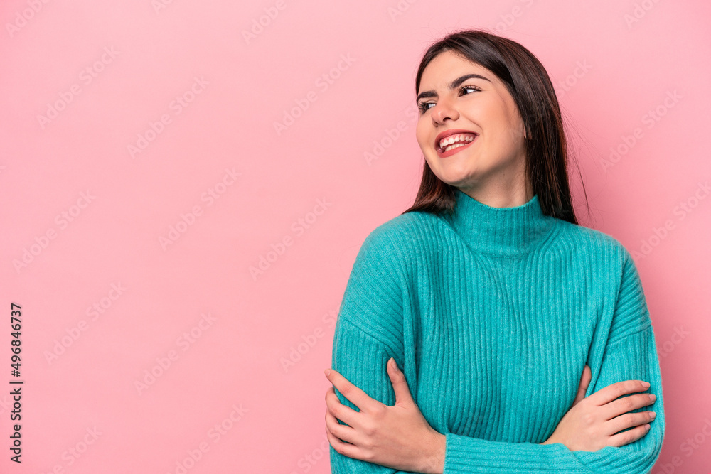 Fototapeta premium Young caucasian woman isolated on pink background smiling confident with crossed arms.