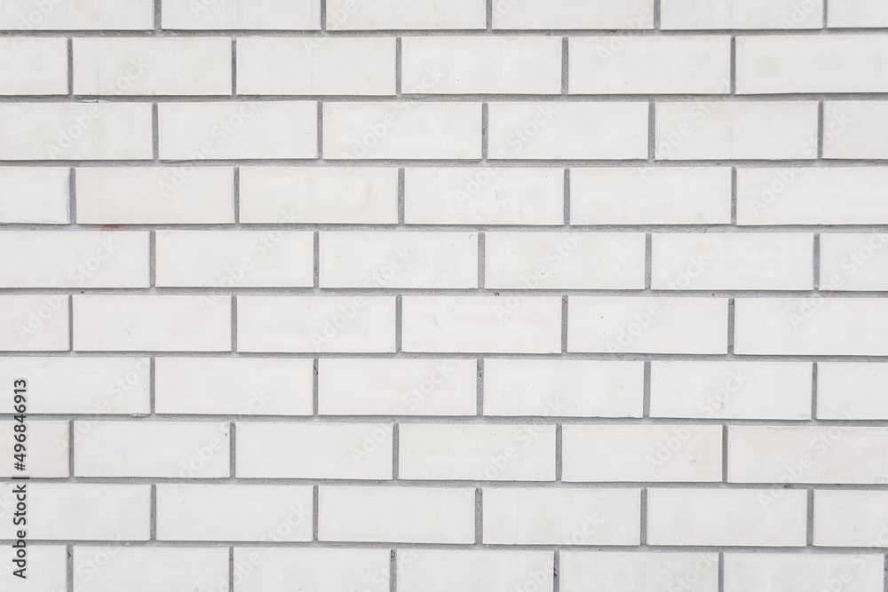 Fototapeta premium The wall is made of white brick. The background is made of gray brickwork