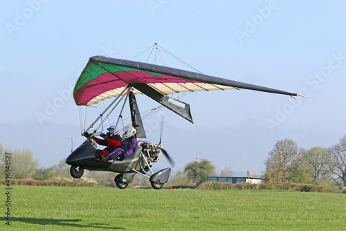Ultralight airplane taking off from a farm strip	