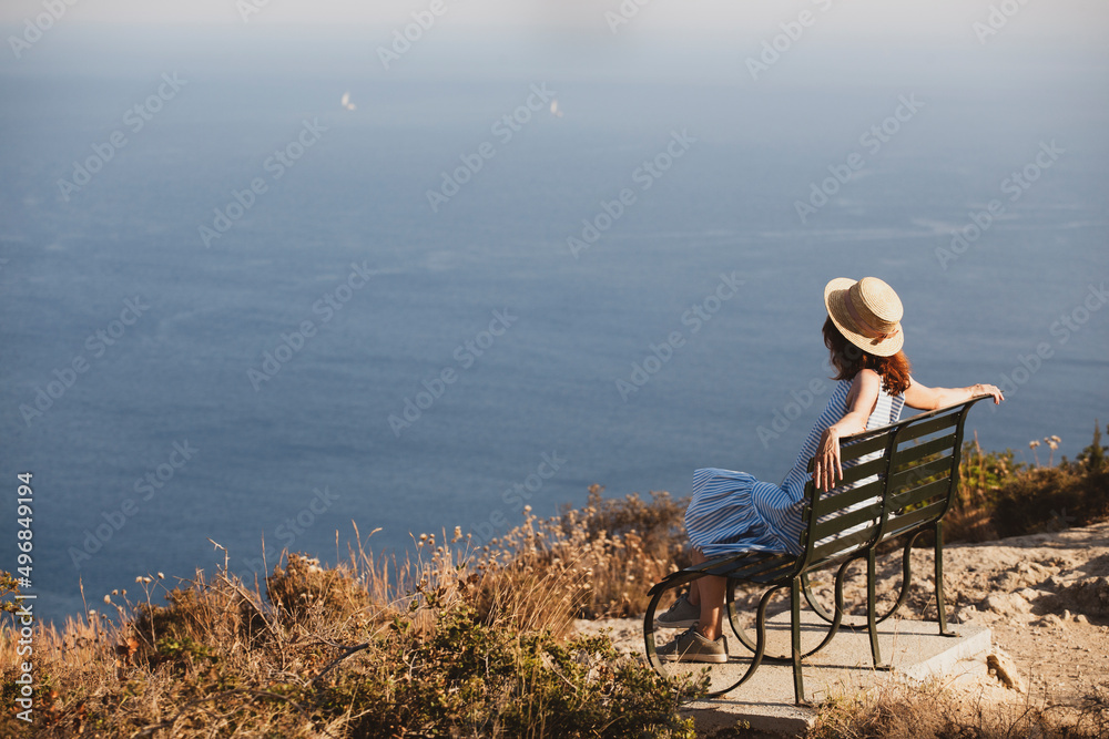 girl tourist sitting on a bench at  the observation deck