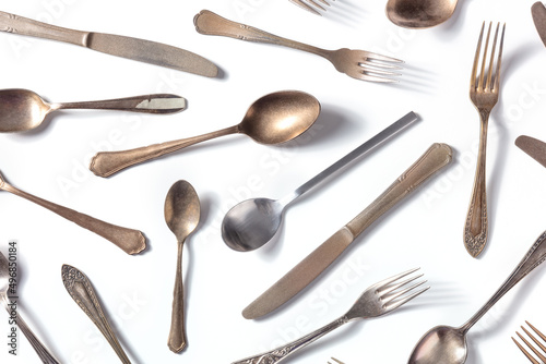 Cutlery pattern. Various forks, knives, and spoons, elegant tableware, overhead flat lay shot on a white background
