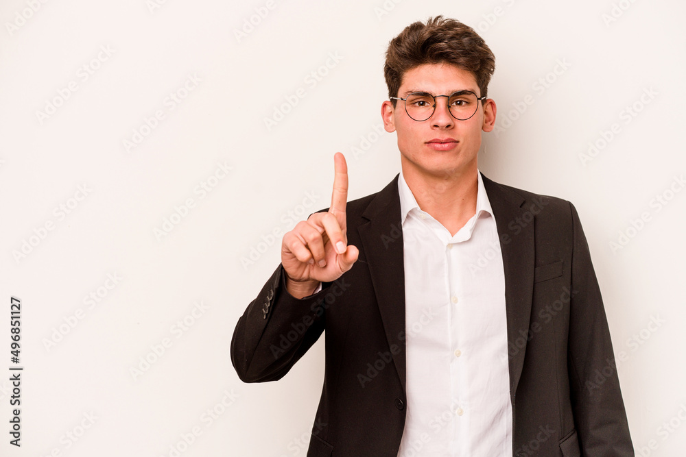 Young caucasian business man isolated on white background showing number one with finger. Young caucasian business man isolated on white background showing number one with finger.