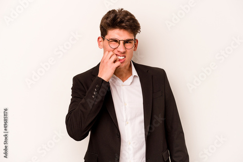 Young caucasian business man isolated on white background biting fingernails, nervous and very anxious.