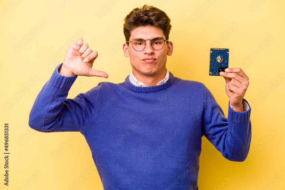Young caucasian informatics man isolated on yellow background showing a dislike gesture, thumbs down. Disagreement concept. Young caucasian informatics man isolated on yellow background showing a dislike gesture, thumbs down. Disagreement concept.