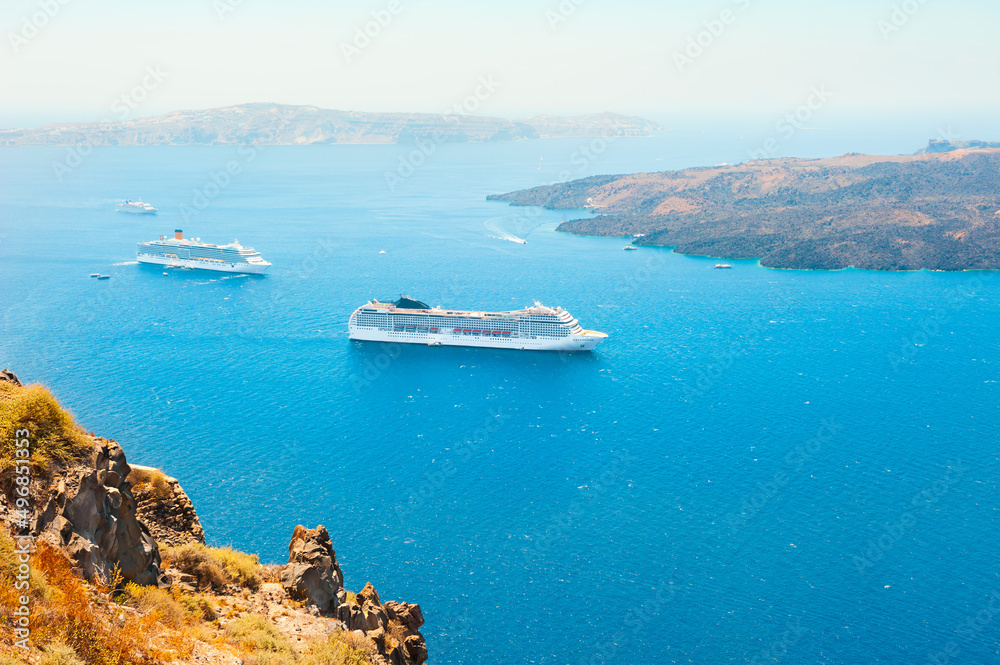 Cruise ship at the sea near the greek islands. Santorini island, Greece.