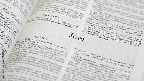 Close Up Shot of  Bible Page Turning to the book of Joel