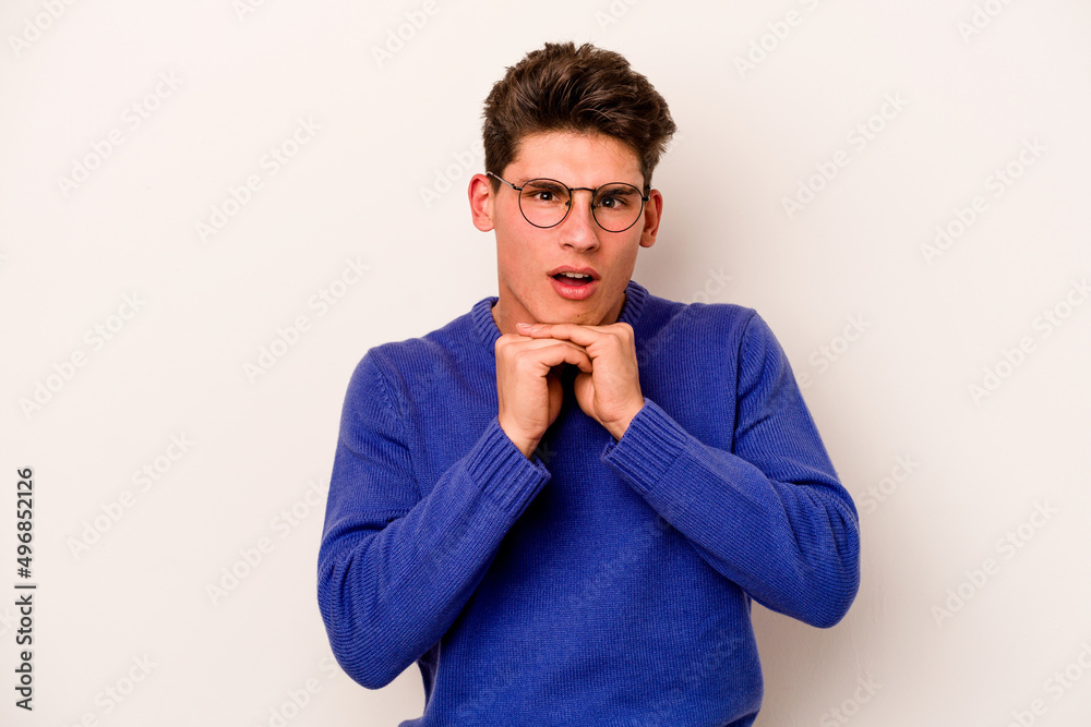 Young caucasian man isolated on white background praying for luck, amazed and opening mouth looking to front. Young caucasian man isolated on white background praying for luck, amazed and opening mouth looking to front.