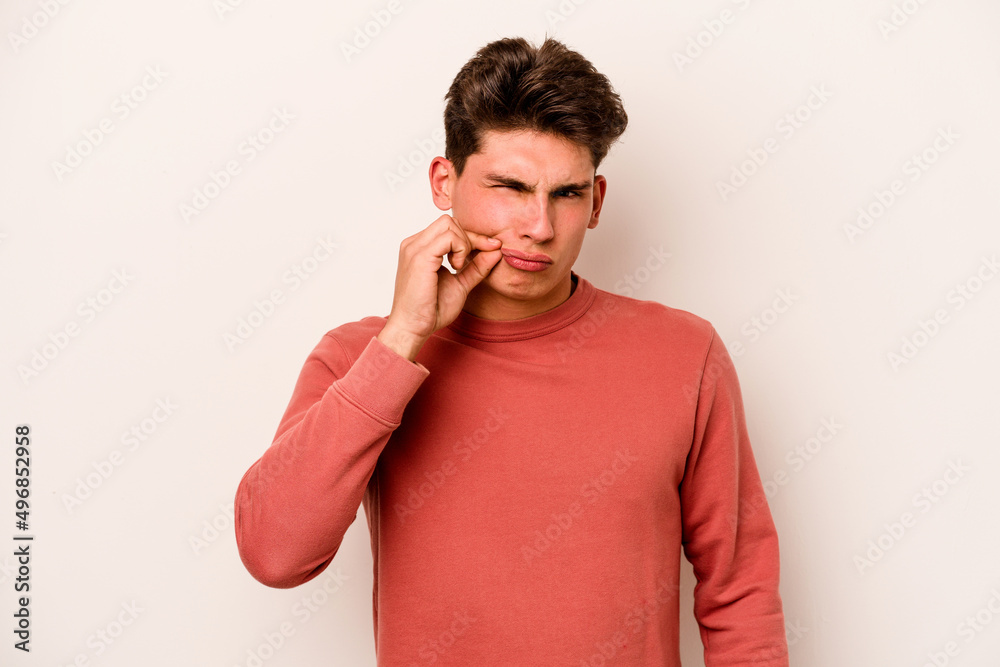 Young caucasian man isolated on white background with fingers on lips keeping a secret. Young caucasian man isolated on white background with fingers on lips keeping a secret.