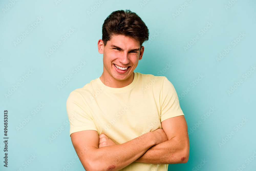 Young caucasian man isolated on blue background laughing and having fun. Young caucasian man isolated on blue background laughing and having fun.