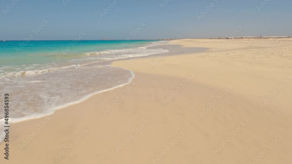 Empty tropical beach with waves rolling on the shore. Empty tropical beach with waves rolling on the shore.